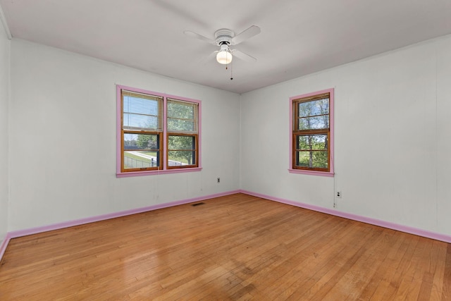 1759 Summertown Hwy, Hohenwald, TN 38462 - empty room featuring visible vents, a ceiling fan, light wood finished floors, and a wealth of natural light
