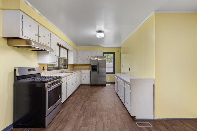 1759 Summertown Hwy, Hohenwald, TN 38462 - kitchen featuring crown molding, appliances with stainless steel finishes, light countertops, dark wood finished floors, and under cabinet range hood