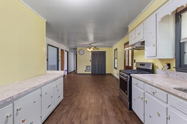 1759 Summertown Hwy, Hohenwald, TN 38462 - kitchen with stainless steel range with gas stovetop, light countertops, dark wood-style flooring, and under cabinet range hood