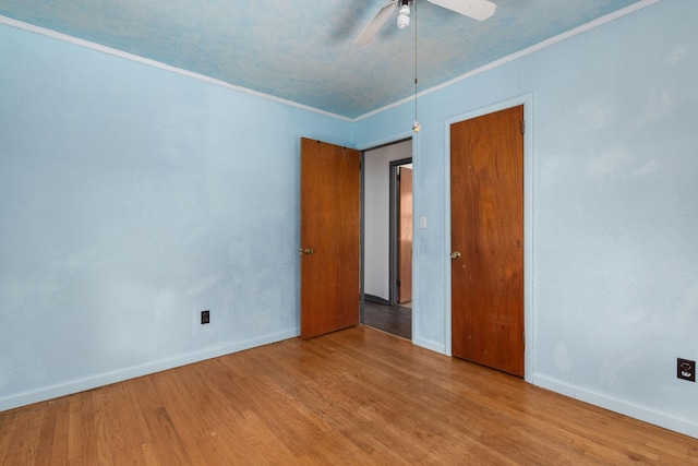 1759 Summertown Hwy, Hohenwald, TN 38462 - unfurnished bedroom featuring crown molding, a ceiling fan, baseboards, and wood finished floors