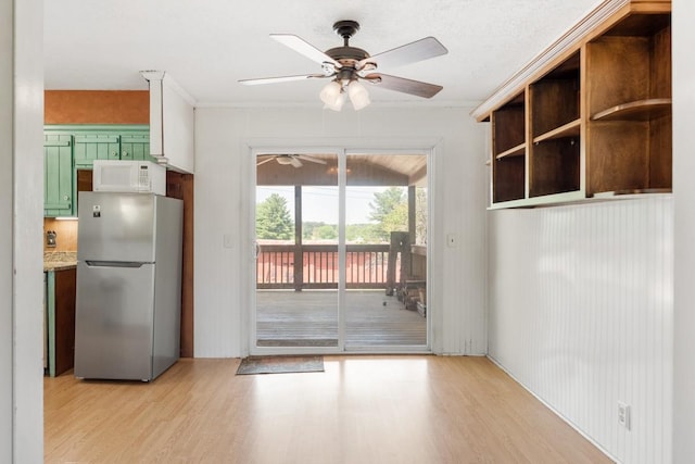 doorway to outside featuring ceiling fan and light wood finished floors