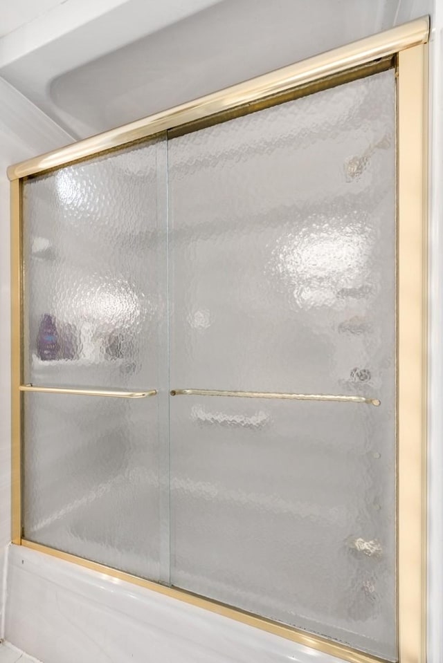 full bathroom with combined bath / shower with glass door