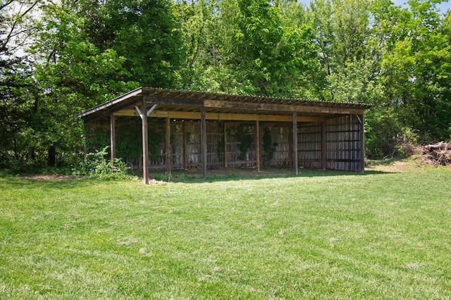 view of pole building with a lawn and a detached carport