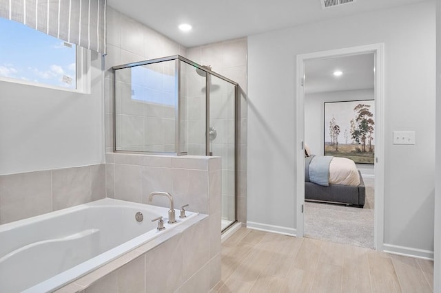 ensuite bathroom featuring visible vents, recessed lighting, connected bathroom, a bath, and a shower stall