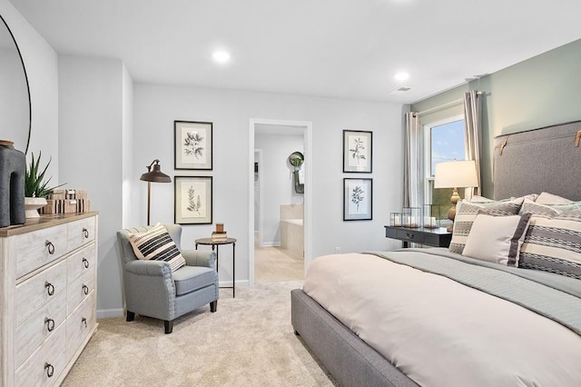 bedroom featuring visible vents, light carpet, baseboards, ensuite bathroom, and recessed lighting
