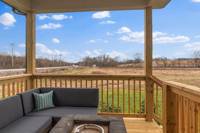 deck featuring an outdoor living space and a rural view