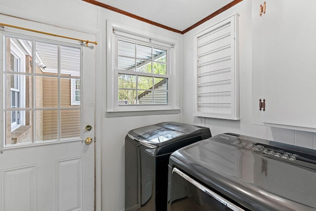 washroom with washer and dryer and ornamental molding