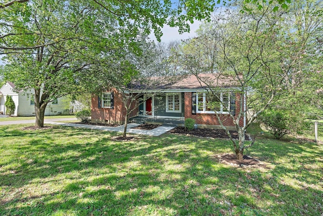 ranch-style home featuring brick siding and a front lawn