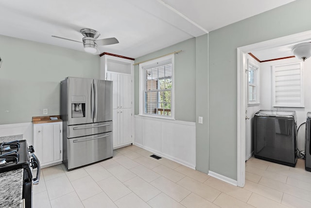 kitchen with white cabinets, stainless steel fridge, a ceiling fan, visible vents, and black gas range