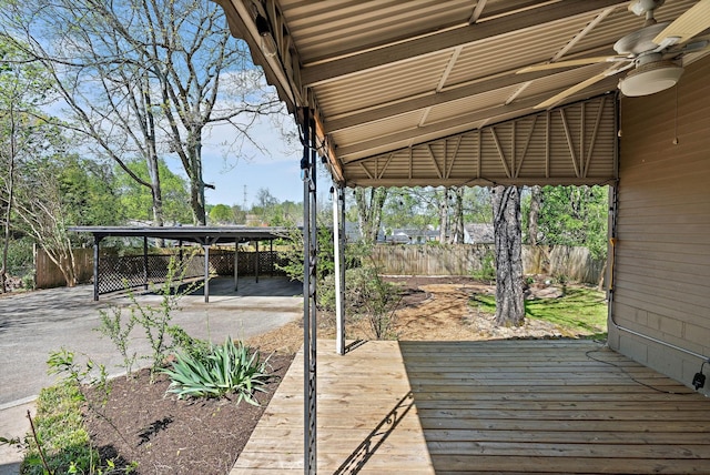 deck with a fenced backyard and a ceiling fan
