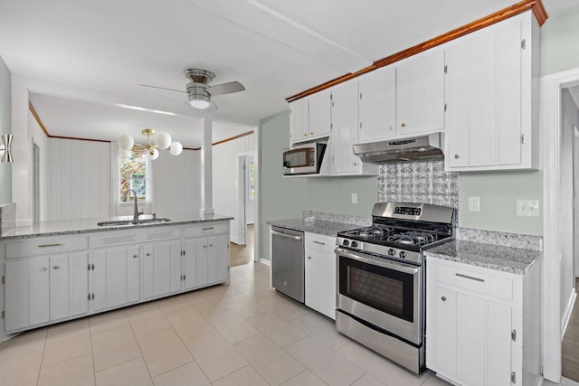 kitchen with ceiling fan with notable chandelier, white cabinetry, under cabinet range hood, a sink, and appliances with stainless steel finishes