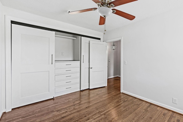 unfurnished bedroom with baseboards, ceiling fan, wood finished floors, and a closet
