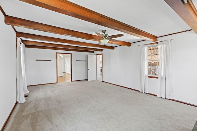 unfurnished living room featuring baseboards, carpet flooring, a ceiling fan, and beam ceiling