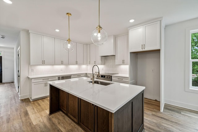 1303 Katie Ave Unit B, Nashville, TN 37207 - kitchen featuring a sink, light wood-style floors, an island with sink, white cabinetry, and backsplash