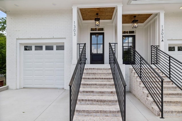 1303 Katie Ave Unit B, Nashville, TN 37207 - doorway to property with brick siding, a garage, board and batten siding, a porch, and driveway