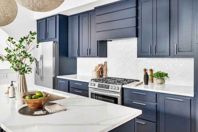 kitchen with decorative backsplash, appliances with stainless steel finishes, and blue cabinets