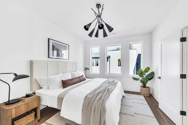 bedroom featuring baseboards and dark wood-style floors