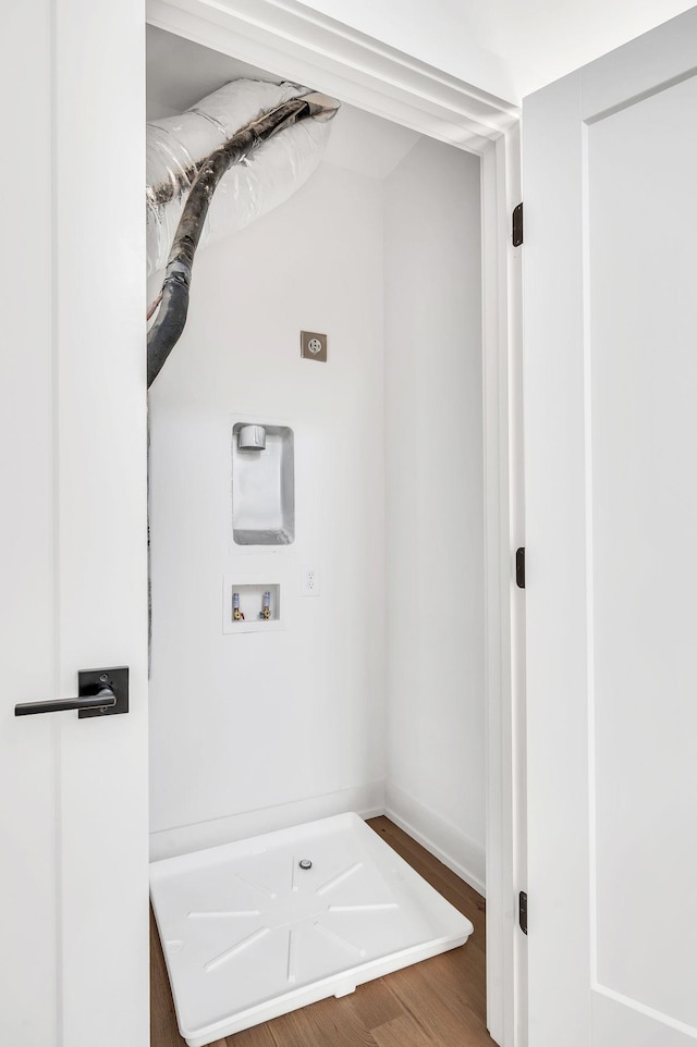 laundry room featuring laundry area, wood finished floors, baseboards, hookup for a washing machine, and hookup for an electric dryer