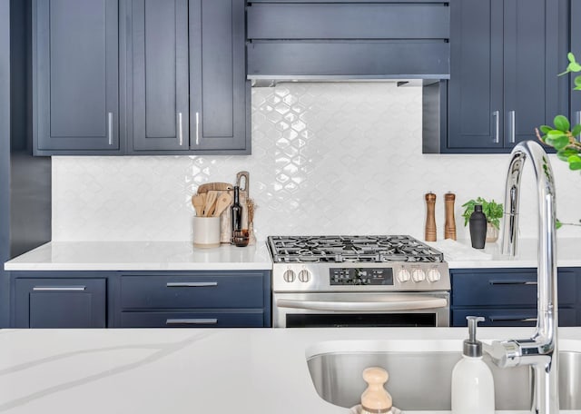 kitchen with light countertops, backsplash, gas stove, and premium range hood