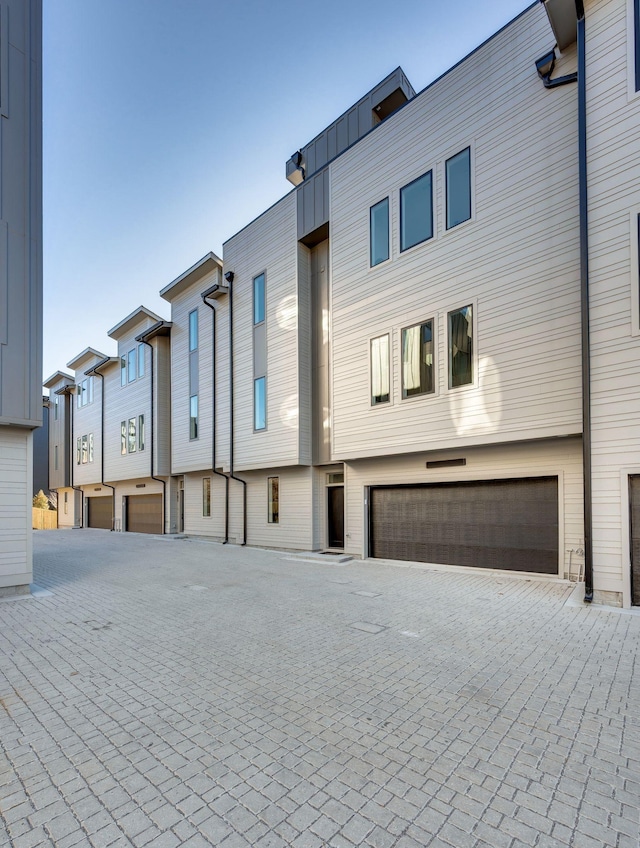 view of property with an attached garage and driveway