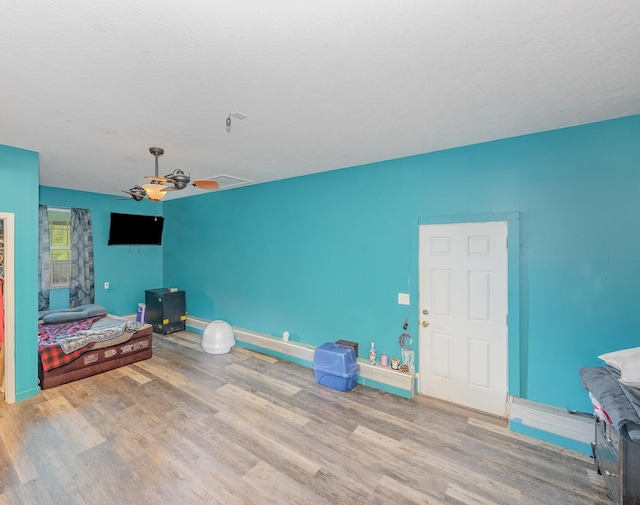 unfurnished living room with baseboards, ceiling fan, and wood finished floors
