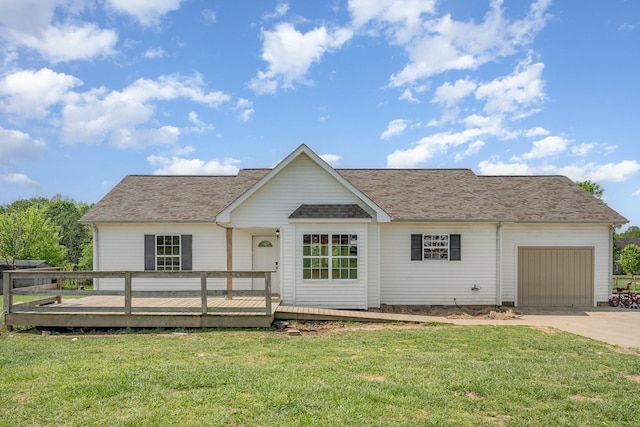 ranch-style home with concrete driveway, a deck, an attached garage, and a front lawn
