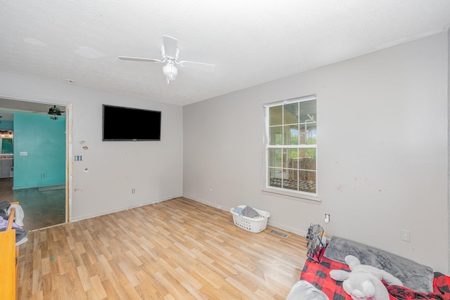 unfurnished room with visible vents, baseboards, ceiling fan, and wood finished floors