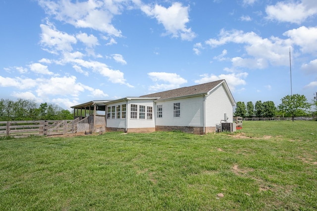 back of house featuring fence, cooling unit, a sunroom, crawl space, and a yard