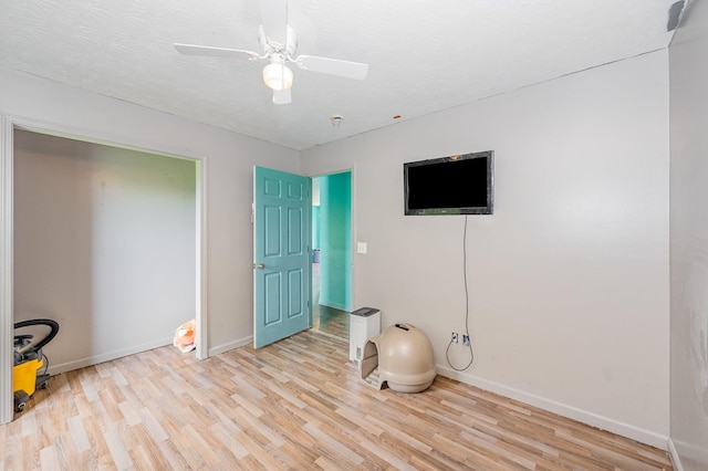 interior space featuring baseboards, ceiling fan, and light wood-type flooring
