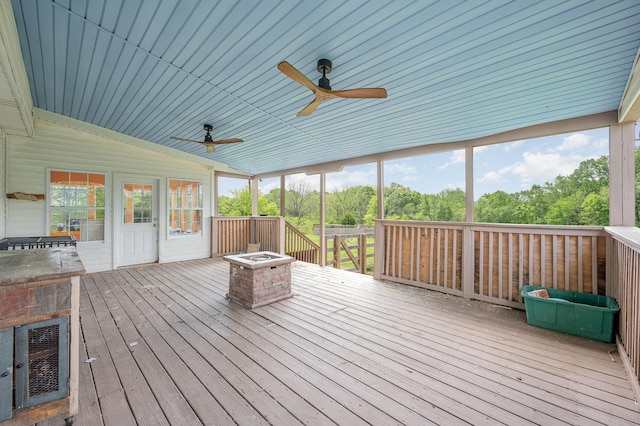 unfurnished sunroom with ceiling fan