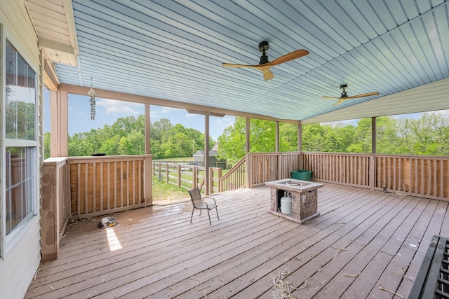exterior space with a ceiling fan and a fire pit