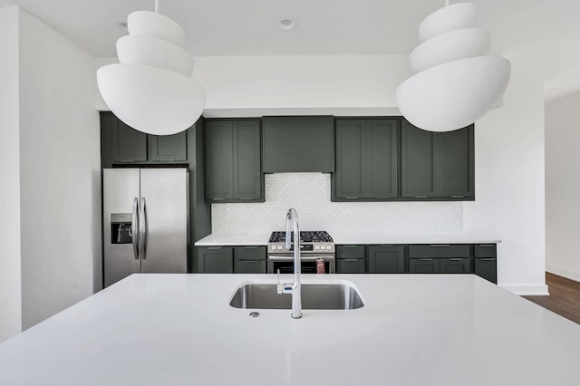 18 Willis St Unit C, Nashville, TN 37207 - kitchen featuring tasteful backsplash, wood finished floors, light countertops, baseboards, and stainless steel appliances