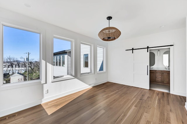 18 Willis St Unit C, Nashville, TN 37207 - interior space featuring baseboards, visible vents, a barn door, and wood finished floors