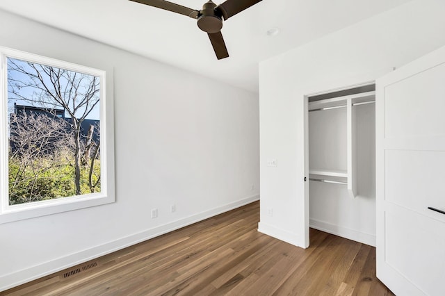 18 Willis St Unit C, Nashville, TN 37207 - unfurnished bedroom featuring baseboards, multiple windows, wood finished floors, and visible vents