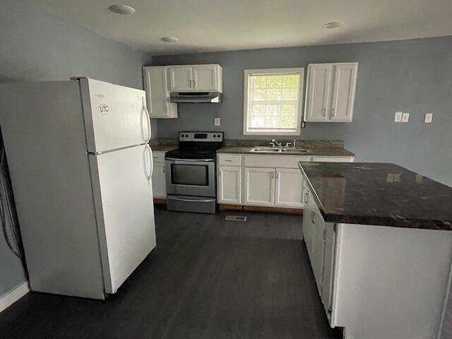 1309 Arlington Ave, Chattanooga, TN 37406 - kitchen with freestanding refrigerator, electric stove, under cabinet range hood, dark countertops, and white cabinets