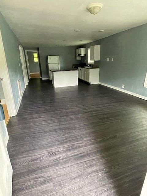 1309 Arlington Ave, Chattanooga, TN 37406 - unfurnished living room featuring baseboards and dark wood finished floors