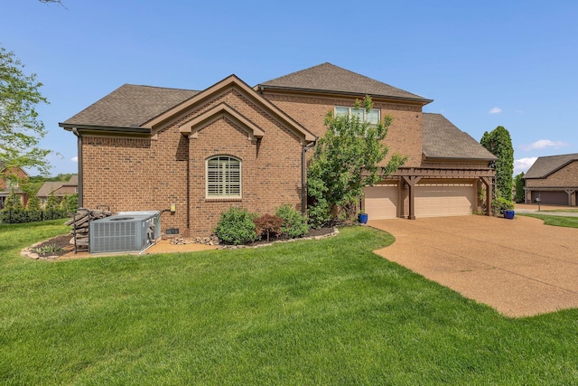 view of front facade with driveway, brick siding, central AC, a front lawn, and a shingled roof