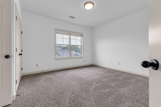 carpeted empty room with baseboards and visible vents