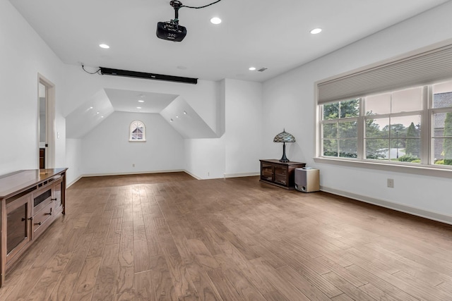bonus room featuring light wood-style floors, baseboards, and recessed lighting