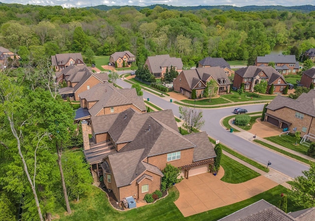 drone / aerial view featuring a forest view and a residential view