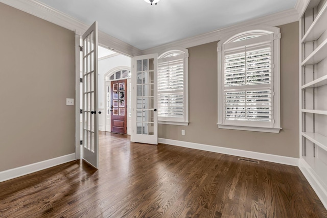 unfurnished room featuring baseboards, ornamental molding, french doors, and wood finished floors