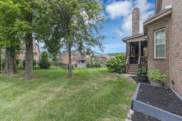 view of yard featuring a fenced backyard, a vegetable garden, and a residential view