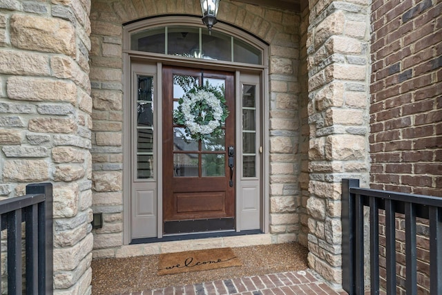 property entrance featuring brick siding and stone siding