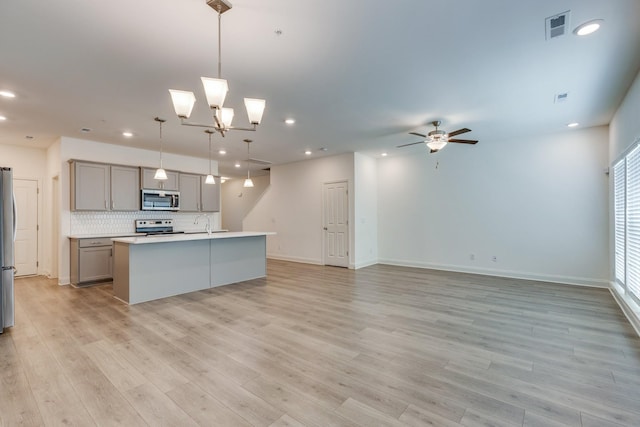 kitchen with visible vents, appliances with stainless steel finishes, gray cabinetry, recessed lighting, and light wood-style flooring