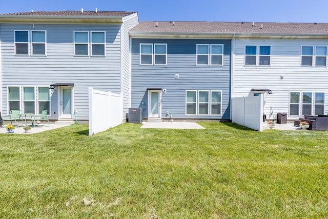 back of house featuring a patio area, fence, and a yard