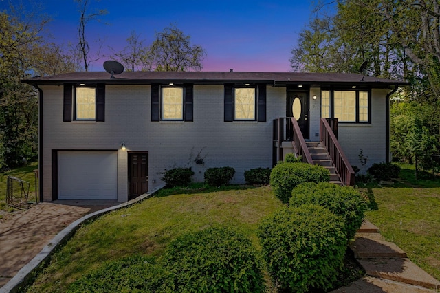 217 Sterry Ct, Antioch, TN 37013 - view of front of home with a yard, brick siding, driveway, and a garage