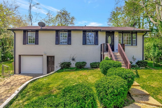 217 Sterry Ct, Antioch, TN 37013 - view of front of house with brick siding, a garage, driveway, and a front yard