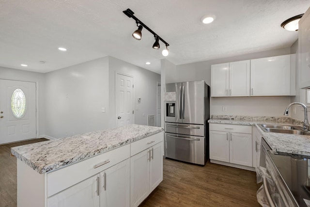 217 Sterry Ct, Antioch, TN 37013 - kitchen with white cabinets, a sink, stainless steel fridge with ice dispenser, a kitchen island, and dark wood-style floors