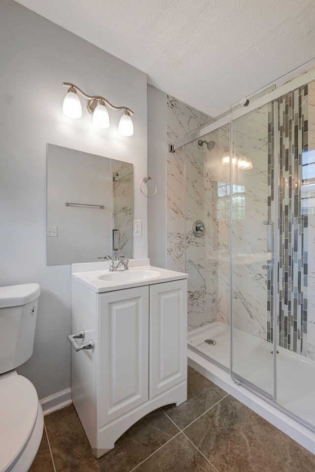 217 Sterry Ct, Antioch, TN 37013 - full bath with a marble finish shower, tile patterned flooring, vanity, and toilet