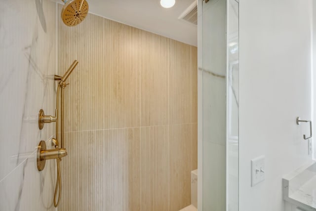 bathroom featuring walk in shower and visible vents